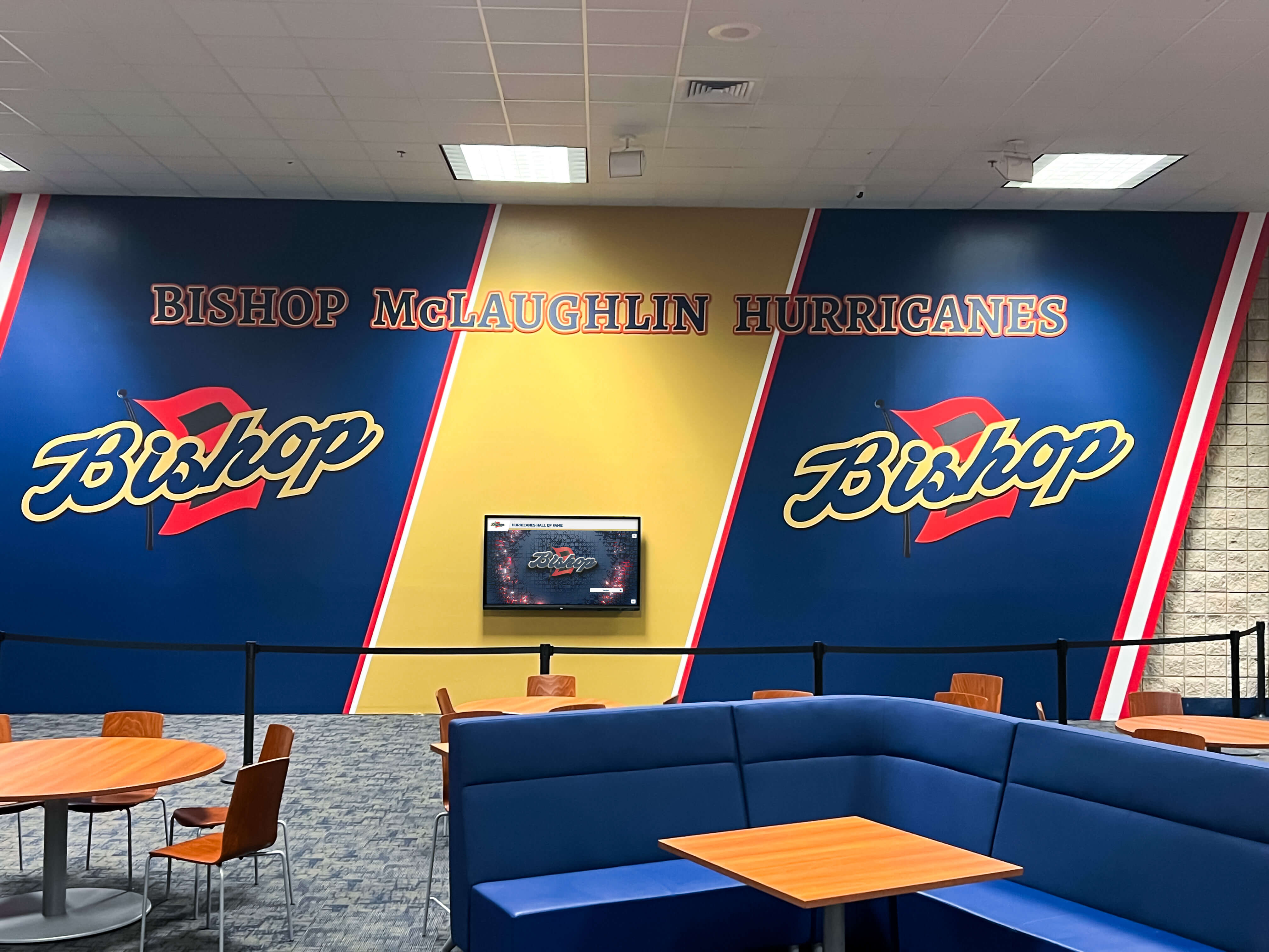 School cafeteria lounge featuring mural celebrating school spirit and student achievement