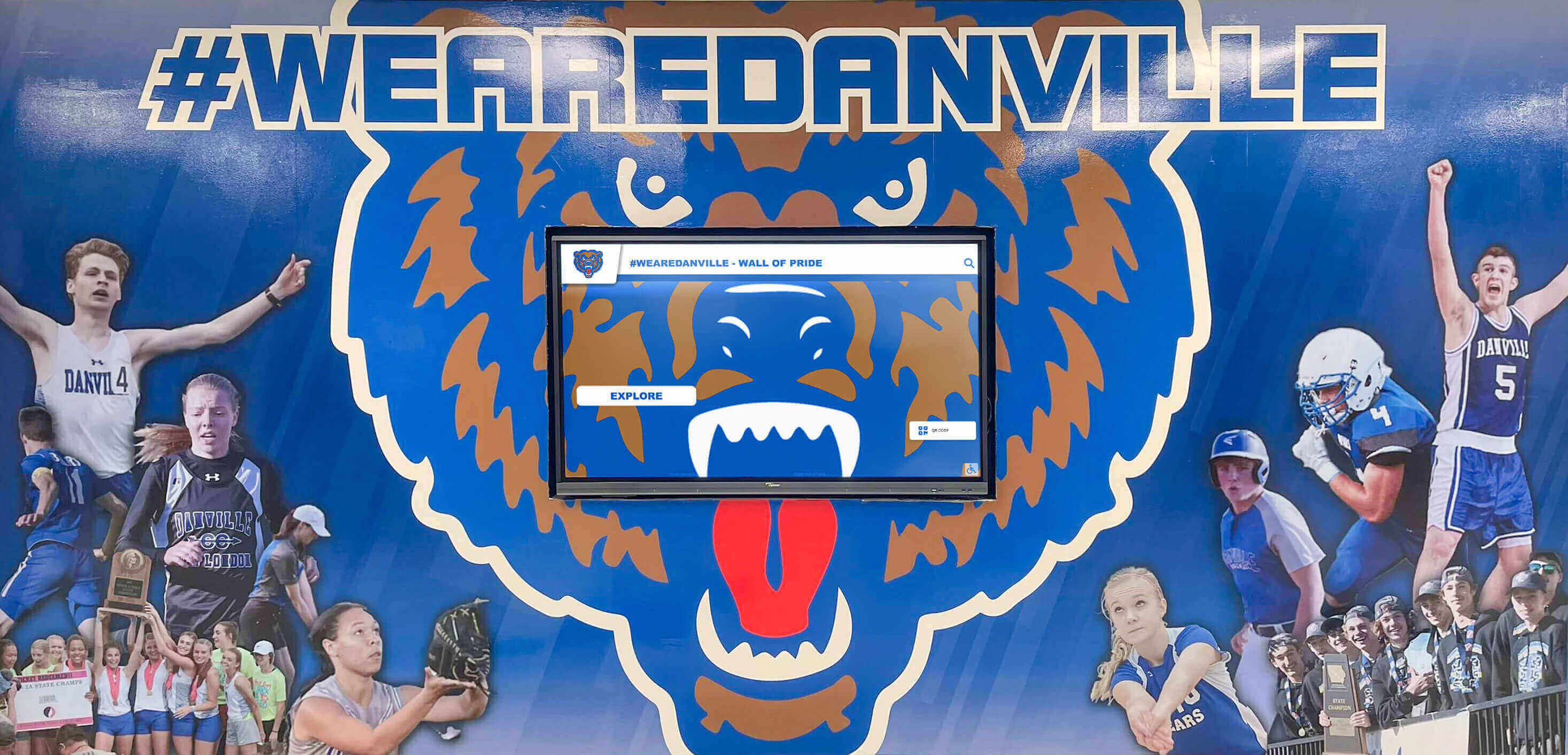 Athletic recognition mural with digital display showcasing championship progression