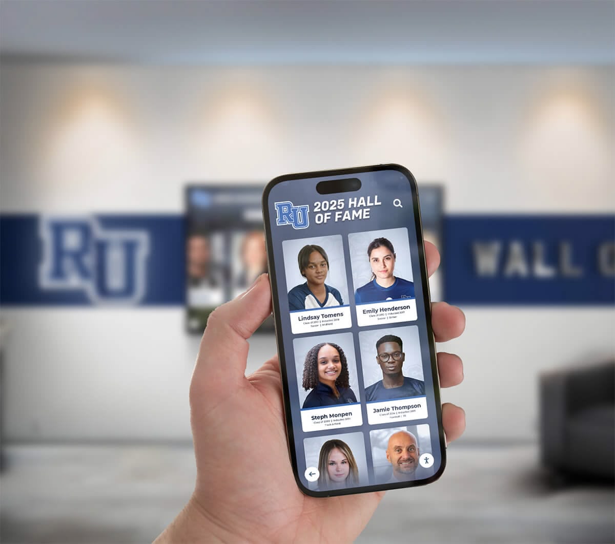 Person using mobile app to explore hall of fame while standing in school lobby