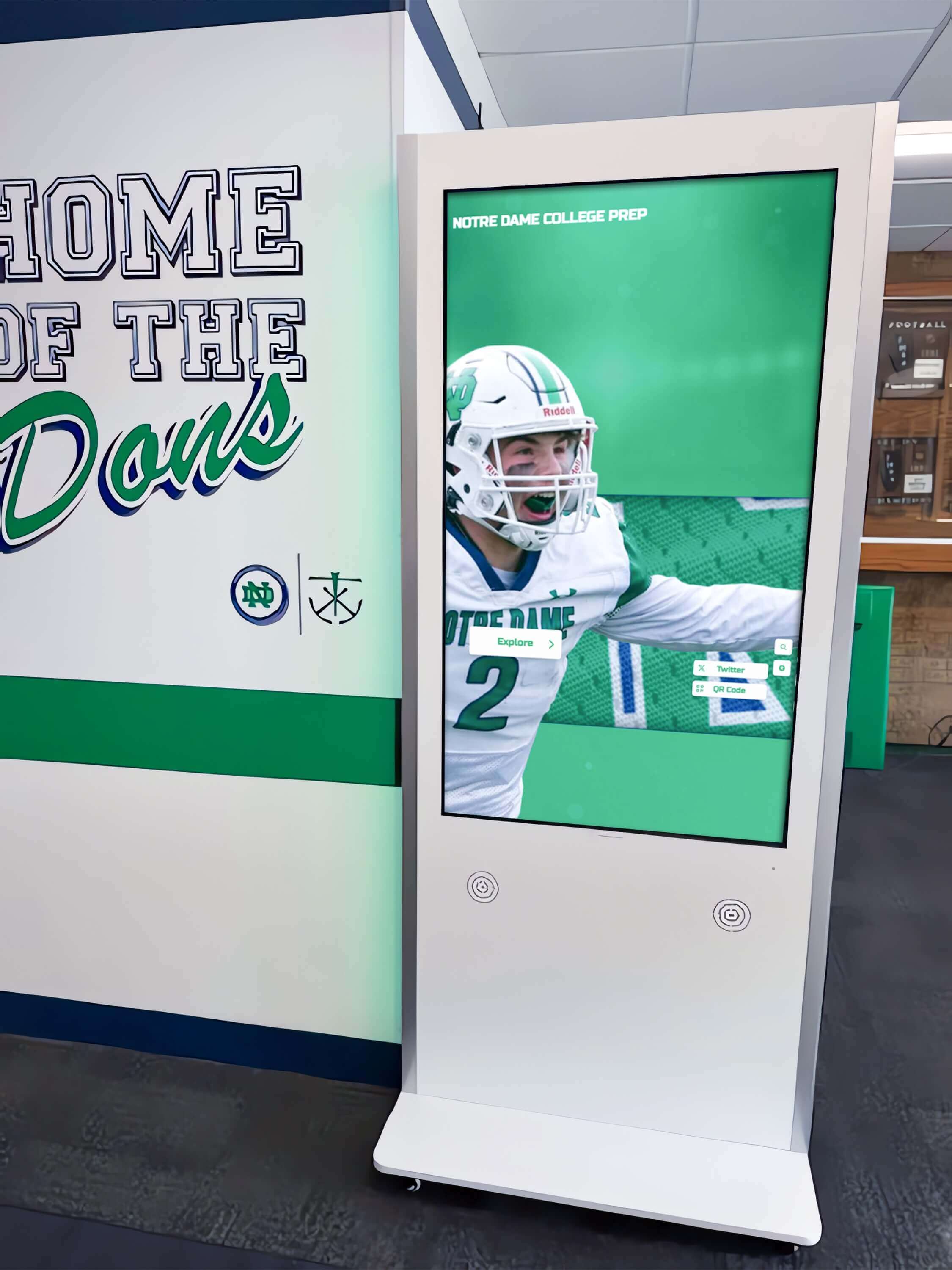 Interactive kiosk displaying football achievements in school hallway