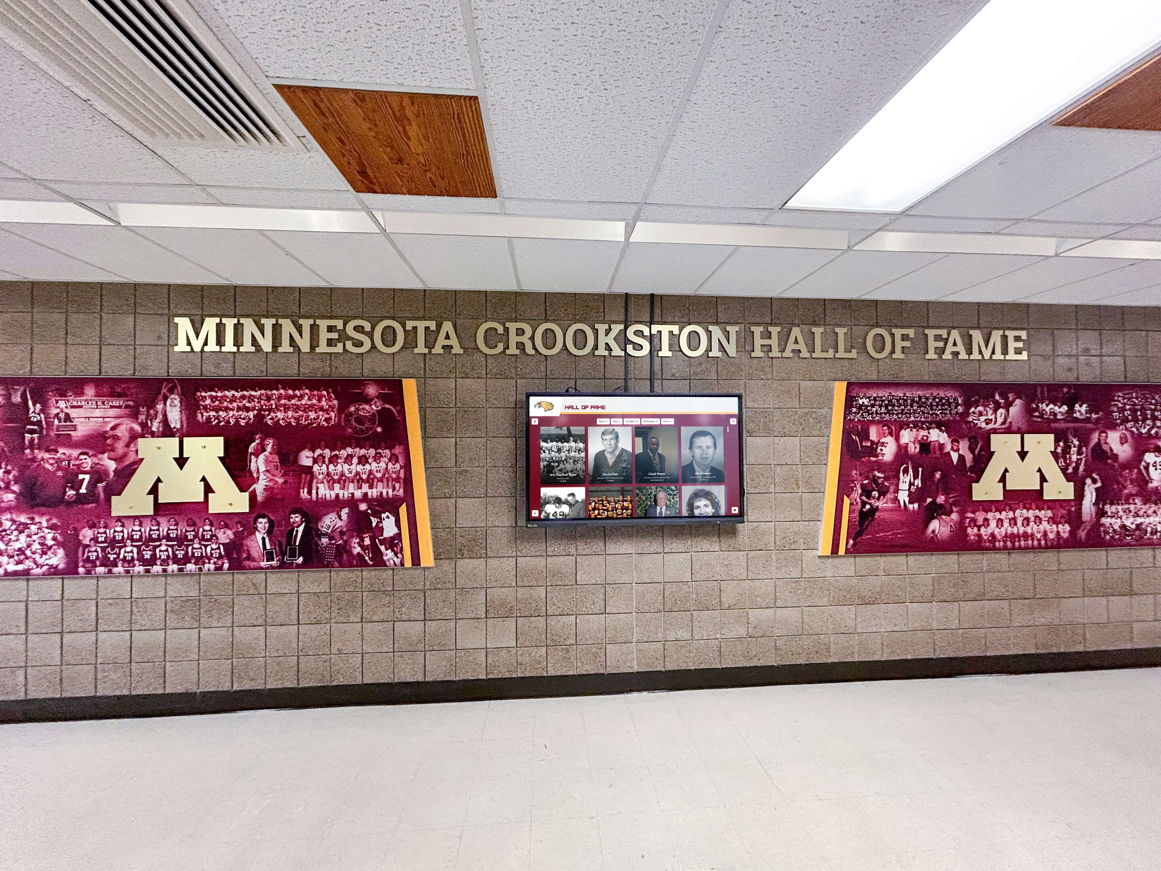 University entrance featuring hall of fame digital display integrated with wall murals
