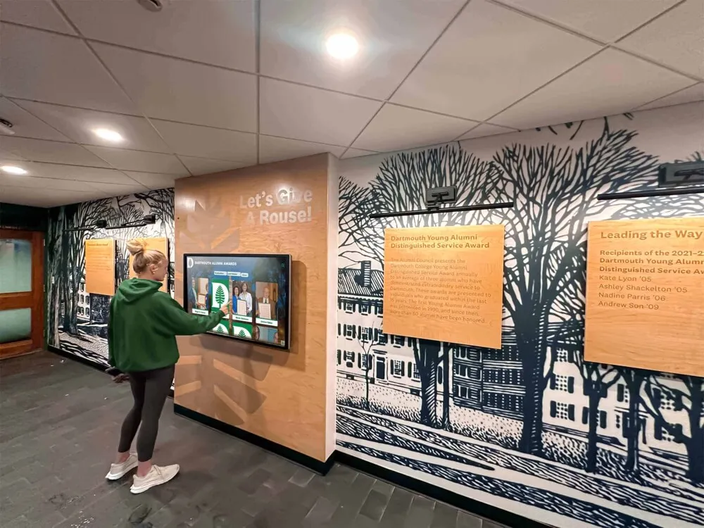 Interactive display showcasing digitized historical content in college hallway