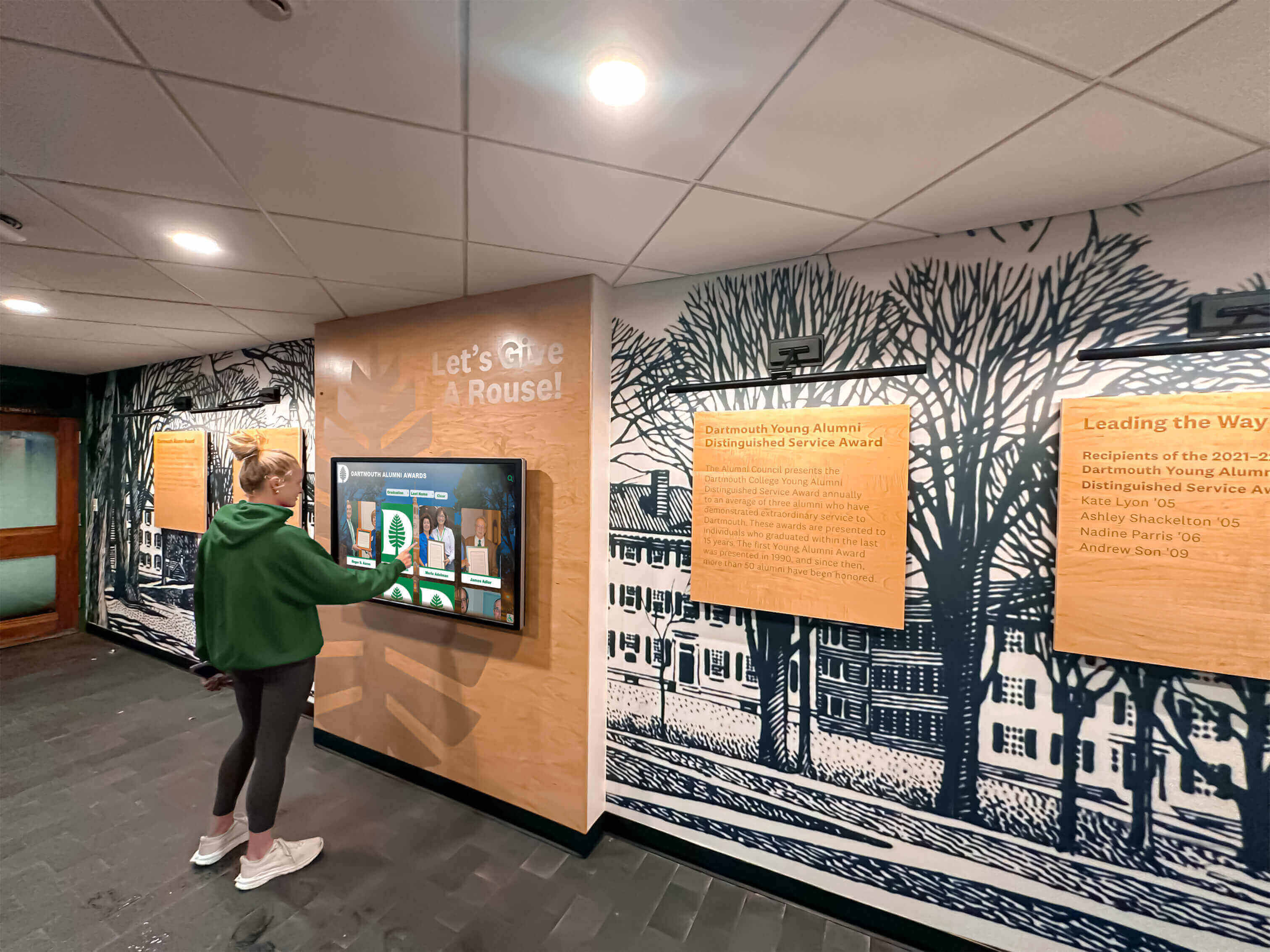 Student exploring historical digital archives on interactive touchscreen display