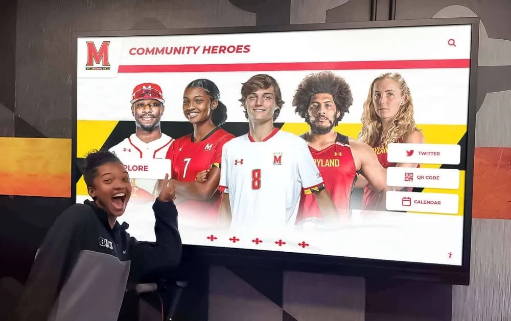 Student interacting with community heroes digital recognition display