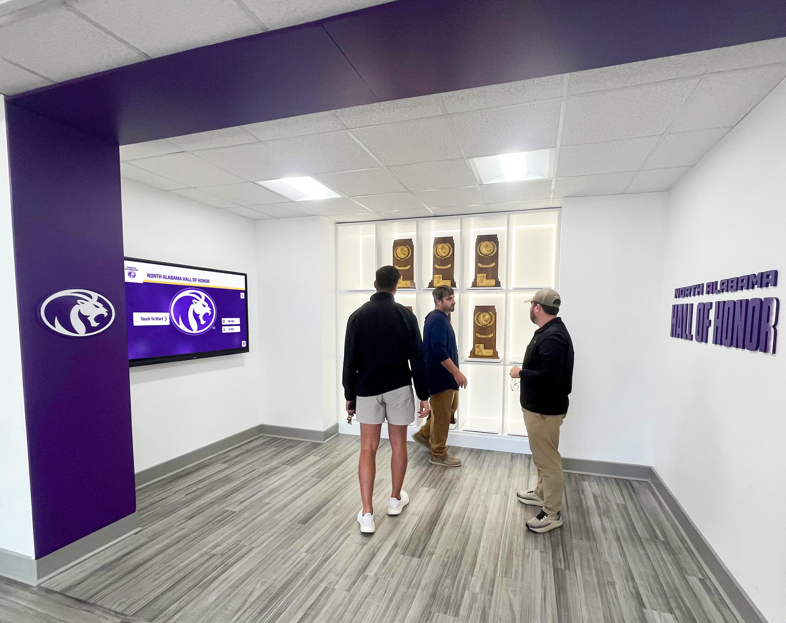Visitors viewing athletic hall of honor recognition display