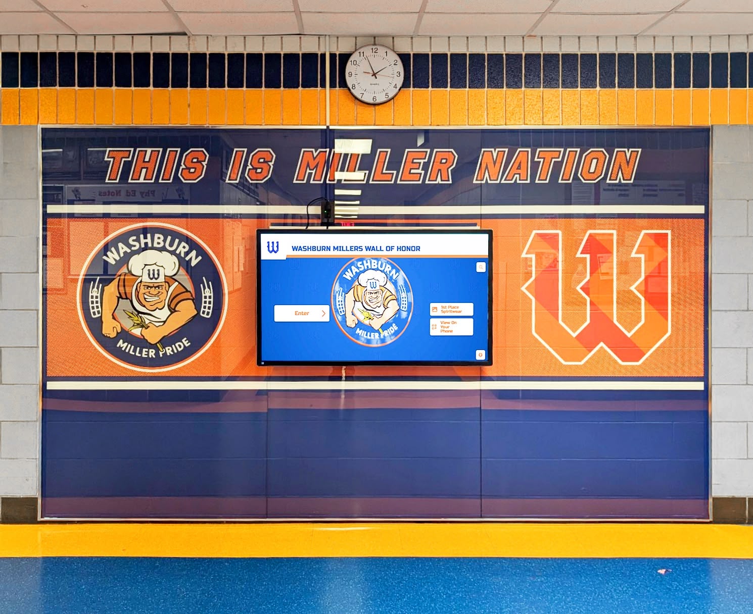 Digital alumni recognition display in school hallway